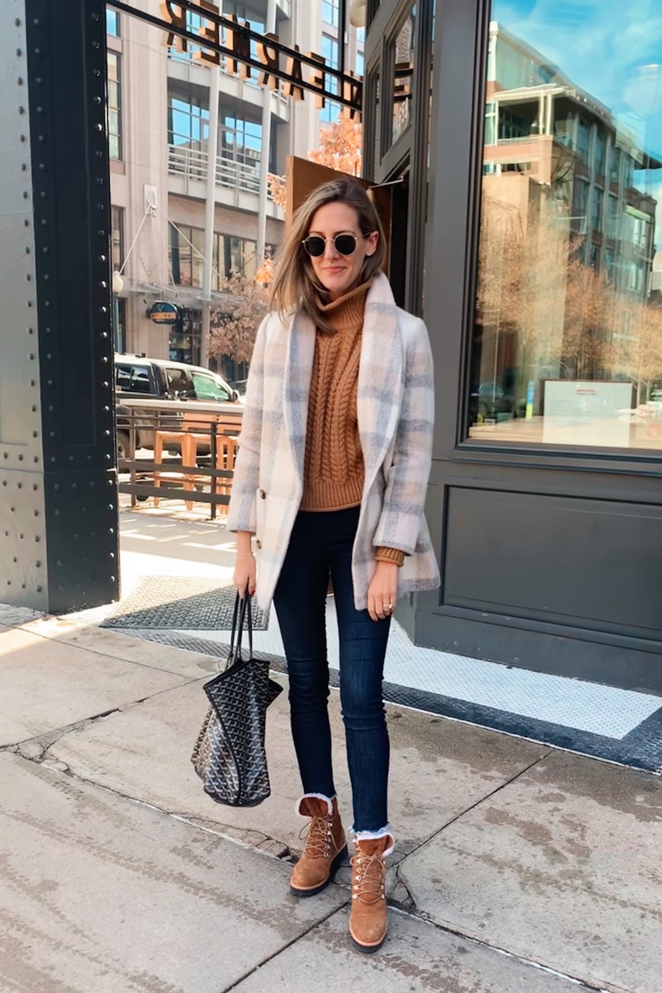 woman sharing her Real outfit recap Date Nights in coat, brown top, and jeans woman sharing her Real outfit recap Date Nights in coat, brown top, and jeans