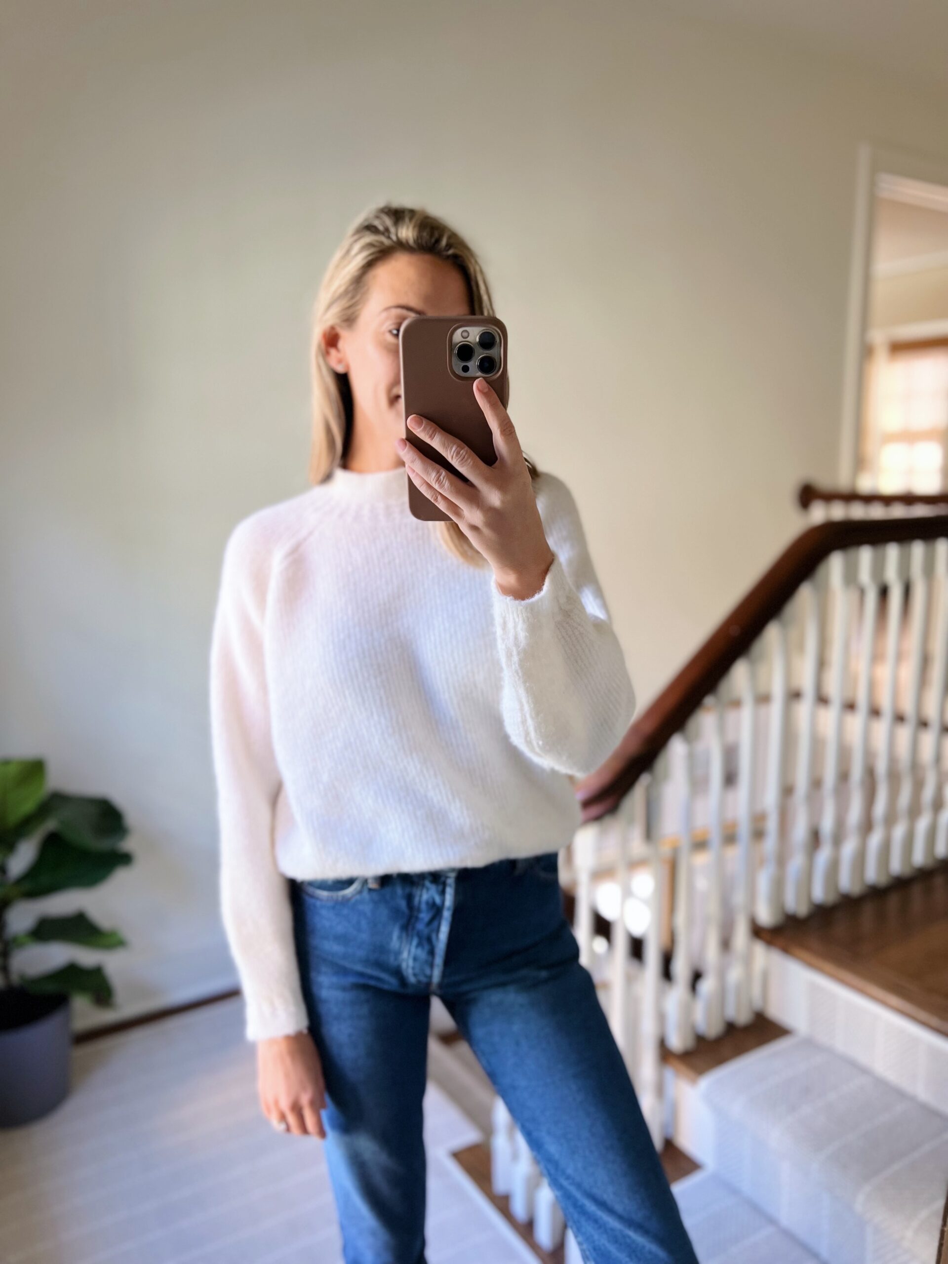 woman wearing white Sézane Knits and jeans woman wearing white Sézane Knits and jeans