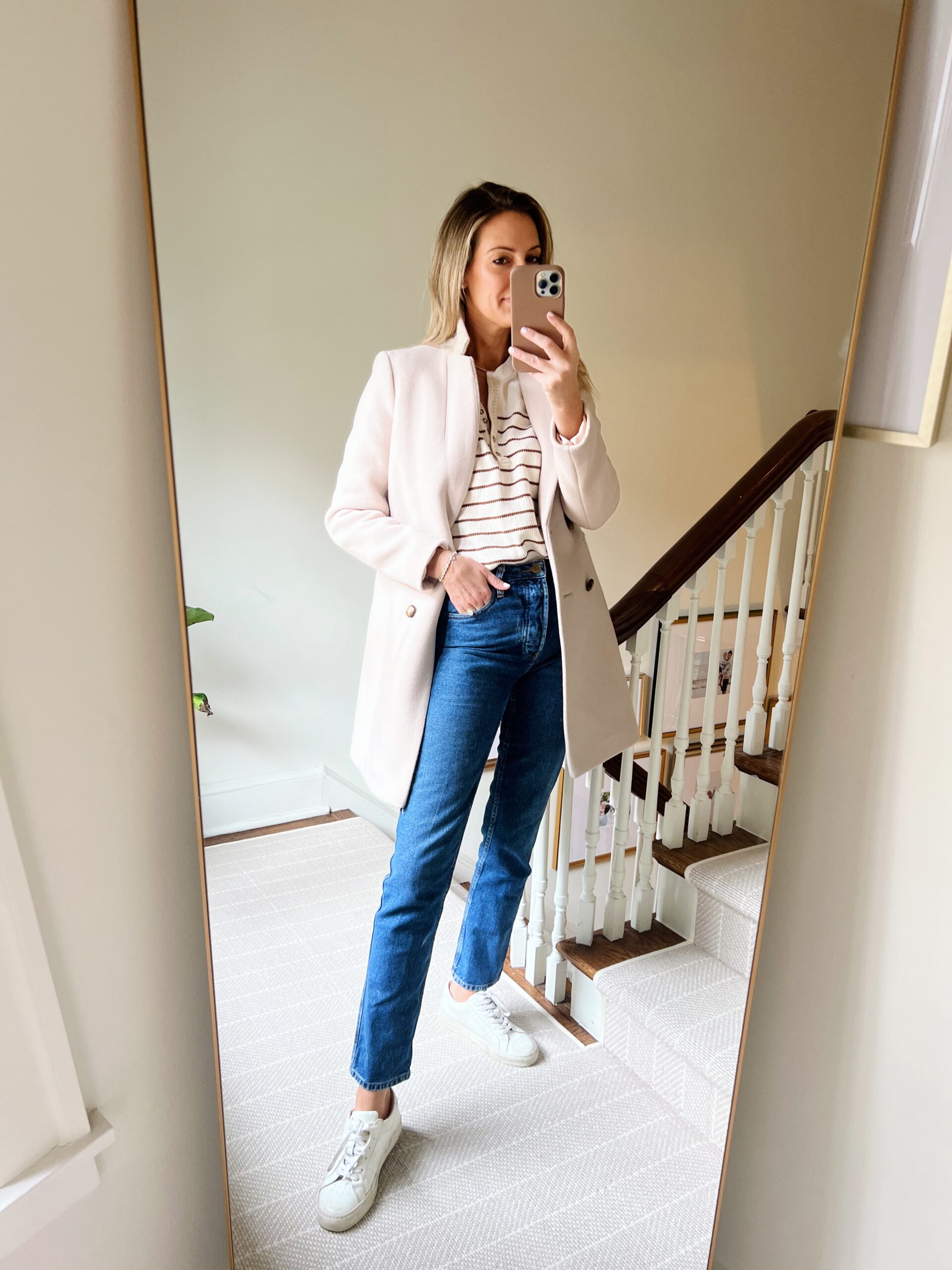 woman in coat, sweater, and jeans from 2022 Recap with Sézane